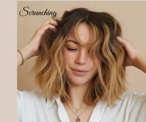 scrunching curly hair with lightweight mousse to enhance natural waves and add volume