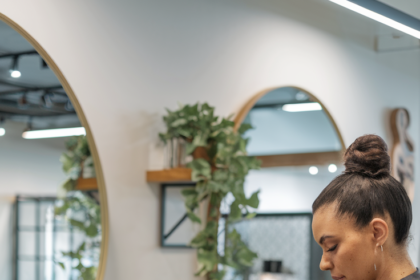 Salon Hair Treatments for Curly Hair - a stylist applying a specialized hair treatment to a client's curly hair in a modern salon setting.